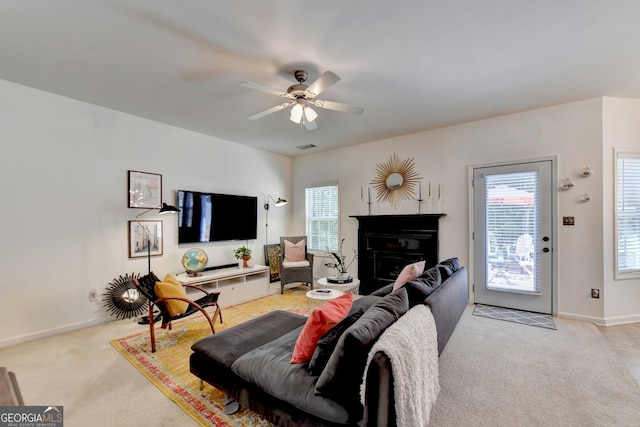 living room with light colored carpet and ceiling fan