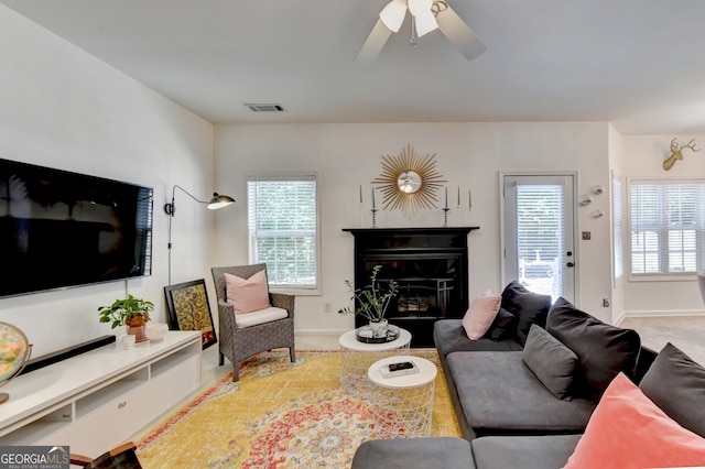 living room with ceiling fan and a healthy amount of sunlight