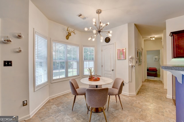 dining area with an inviting chandelier