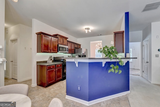 kitchen featuring stainless steel appliances and a breakfast bar area