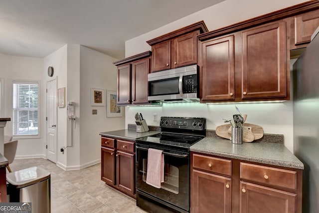 kitchen with appliances with stainless steel finishes and light tile patterned floors