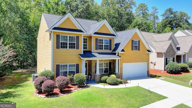 view of front of house with a garage and a front lawn