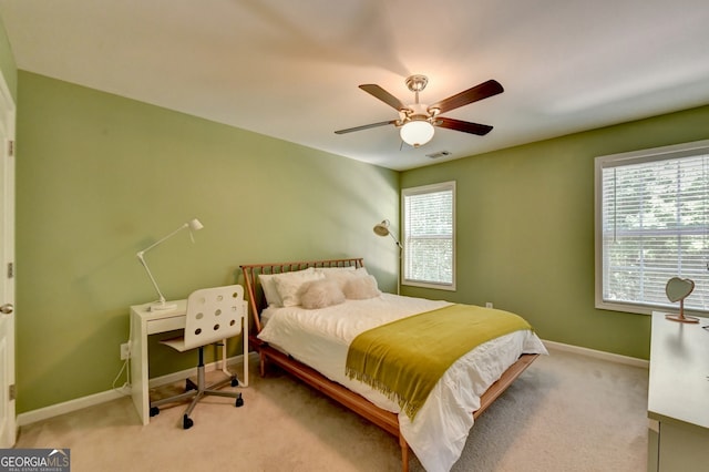 bedroom featuring light colored carpet and ceiling fan