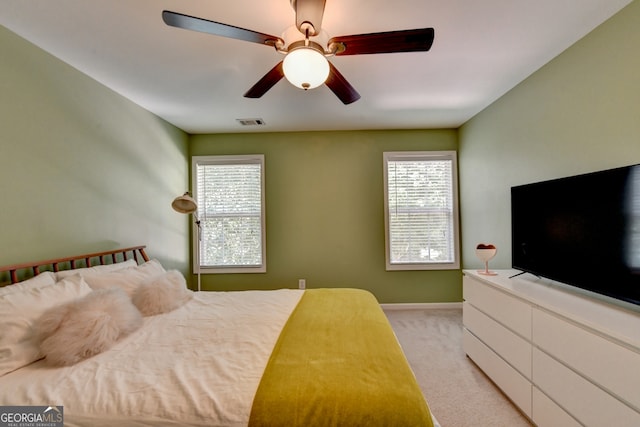 bedroom featuring light colored carpet and ceiling fan