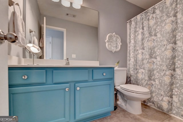 bathroom featuring tile patterned flooring, vanity, and toilet