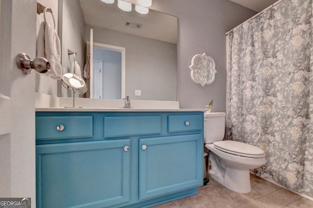 bathroom featuring vanity, toilet, and tile patterned floors