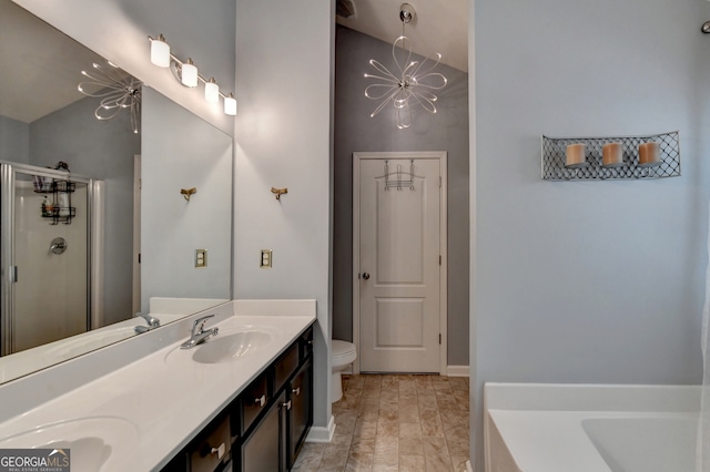 full bathroom featuring vanity, vaulted ceiling, an inviting chandelier, separate shower and tub, and toilet