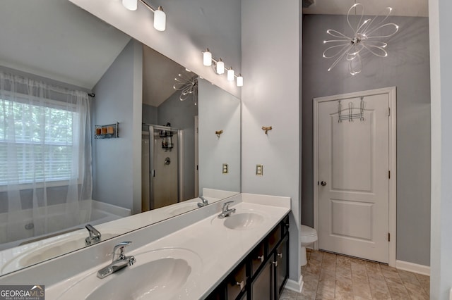 full bathroom with vanity, toilet, separate shower and tub, and lofted ceiling