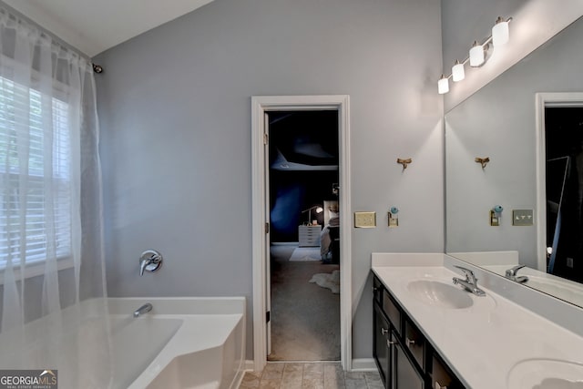 bathroom featuring vanity and a bath