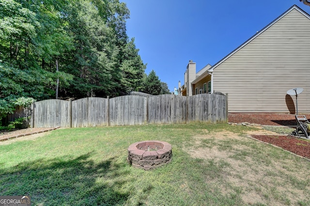 view of yard with a fire pit