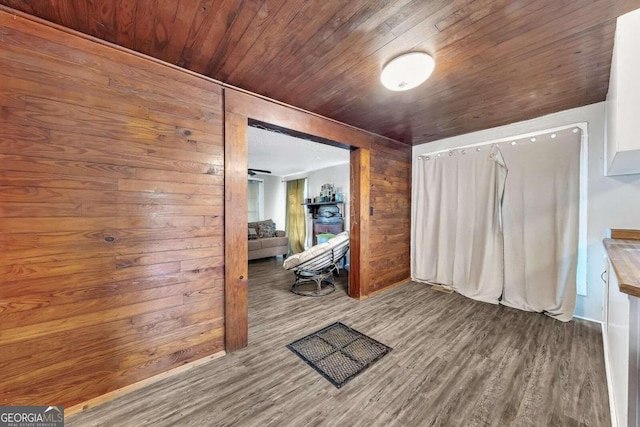 interior space with wood ceiling, wood-type flooring, and wooden walls