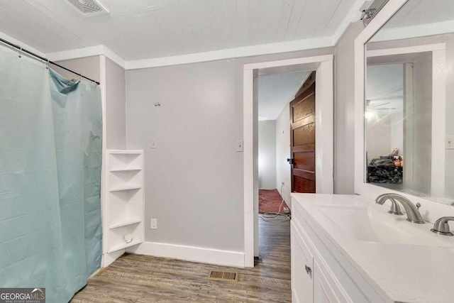 bathroom with a shower with curtain, wood-type flooring, and vanity