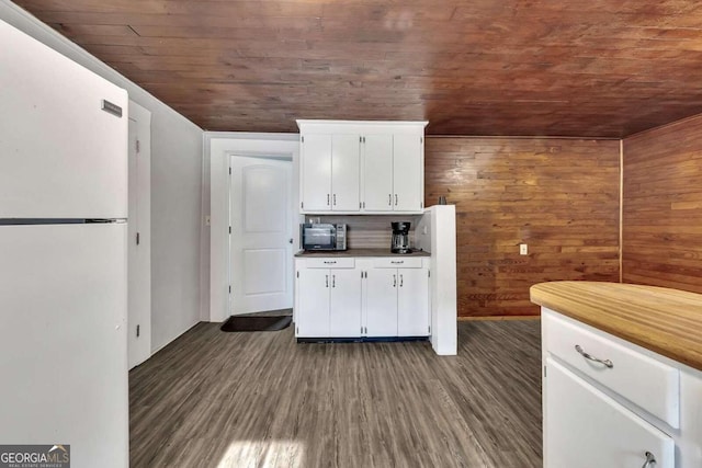 kitchen featuring white refrigerator, white cabinetry, wood ceiling, and dark wood-type flooring