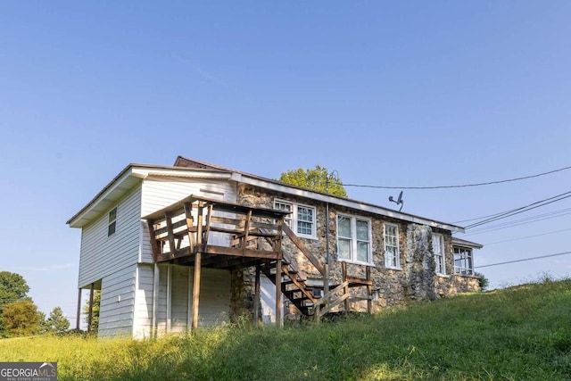 back of house featuring a deck