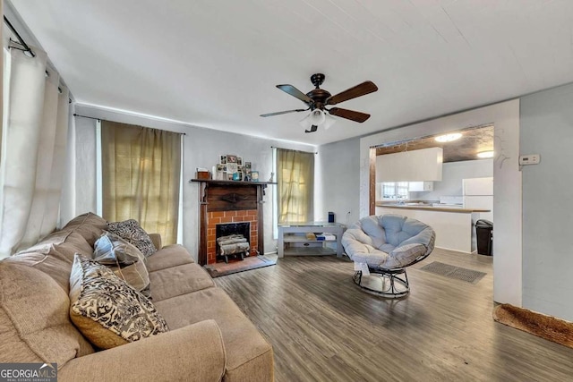 living room featuring wood-type flooring and ceiling fan