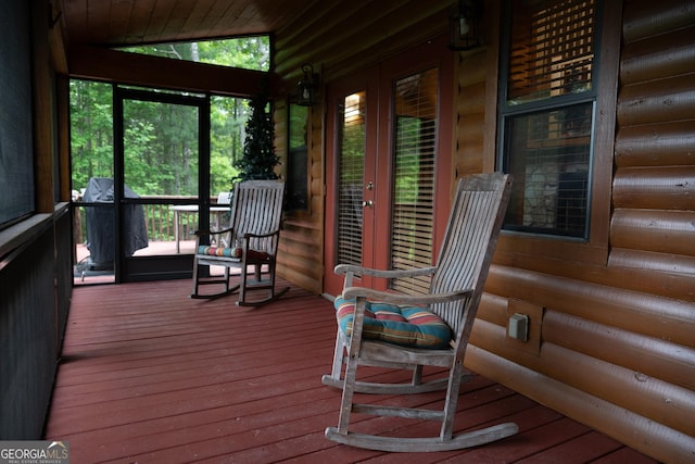 sunroom / solarium featuring french doors