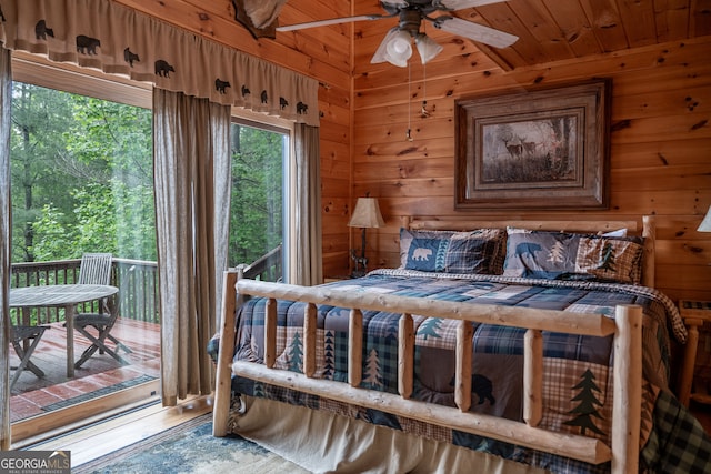 bedroom with wood walls, wood-type flooring, and ceiling fan