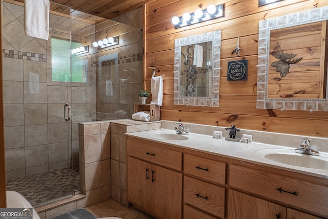 bathroom with vanity, wooden walls, and a shower with door