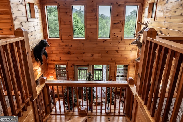 stairway featuring a wealth of natural light and hardwood / wood-style flooring