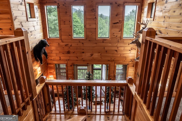 hallway with hardwood / wood-style flooring and wooden walls