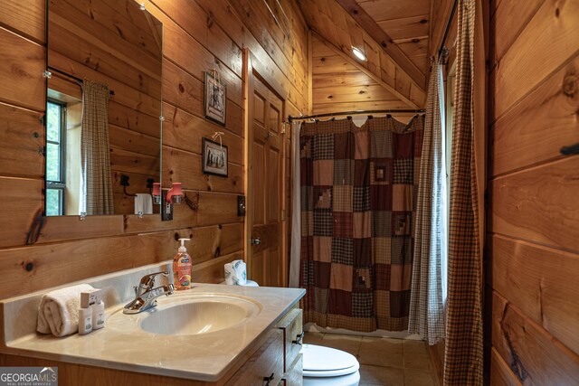 bathroom featuring wood walls, wood ceiling, toilet, vanity, and tile patterned floors