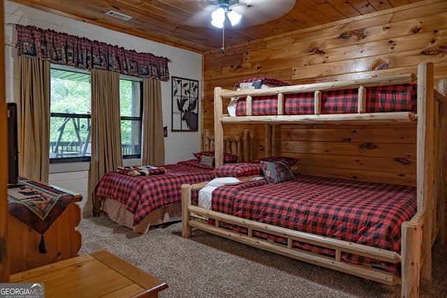 carpeted bedroom featuring wooden ceiling and ceiling fan