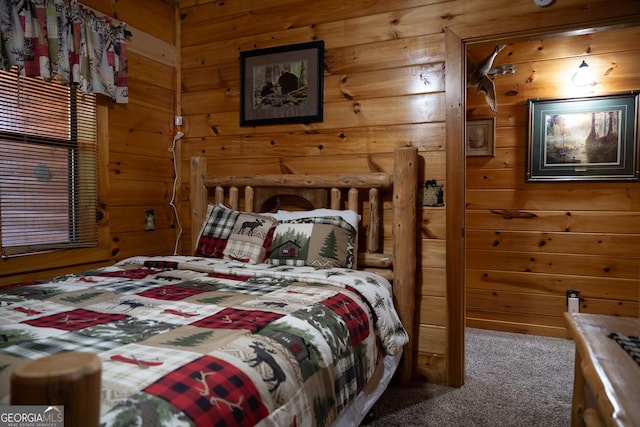 carpeted bedroom with wood walls