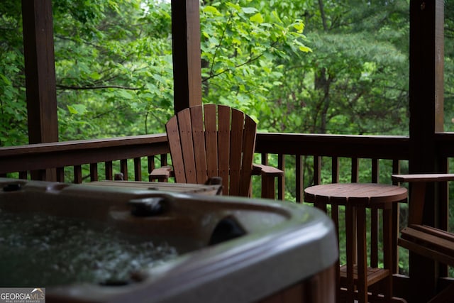 wooden terrace with a hot tub