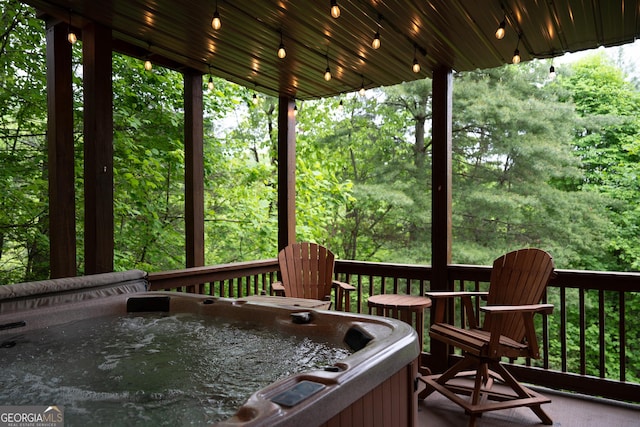 wooden deck featuring a hot tub