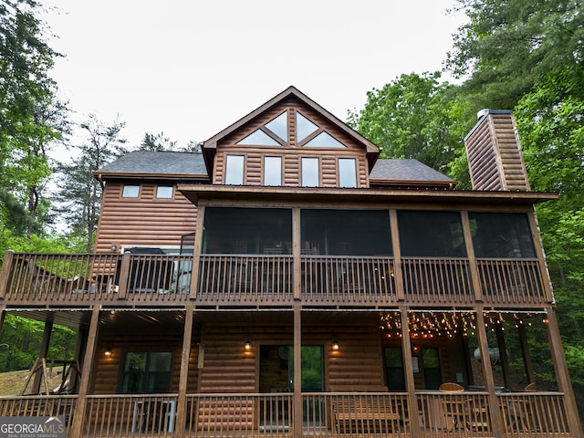 exterior space featuring a sunroom and a deck