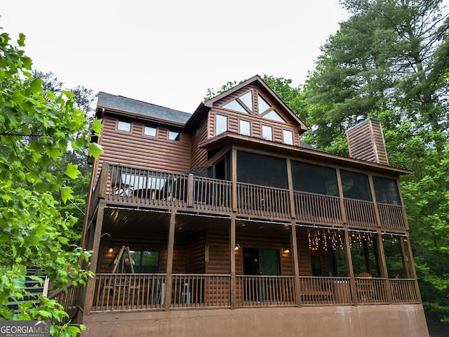 back of house with a sunroom