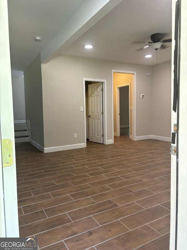 spare room featuring ceiling fan and dark hardwood / wood-style flooring