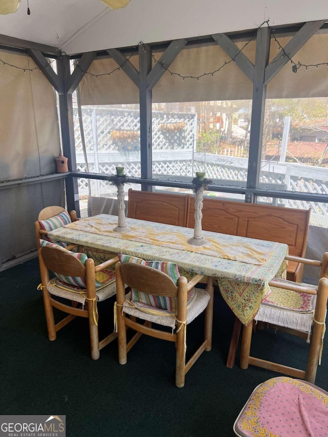 carpeted dining area with a healthy amount of sunlight