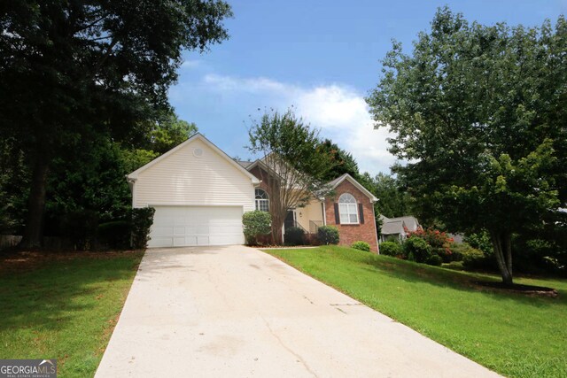 view of front of property with a garage and a front yard