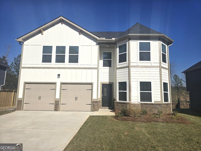 view of front of property with a garage and a front lawn