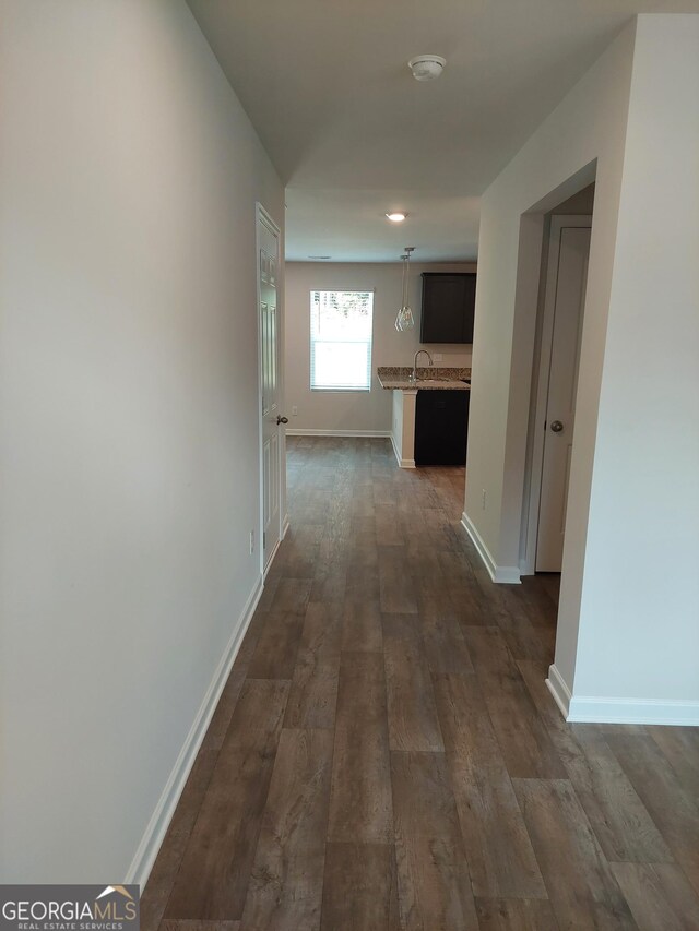 corridor with dark wood-type flooring