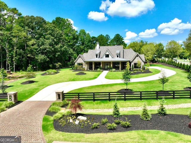 view of home's community featuring a lawn