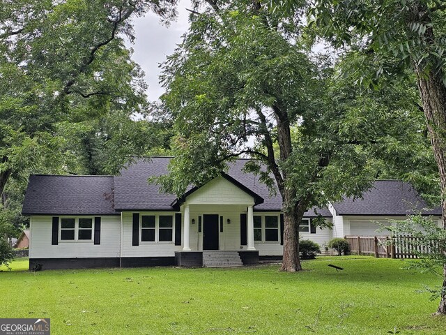 exterior space featuring cooling unit and a front lawn