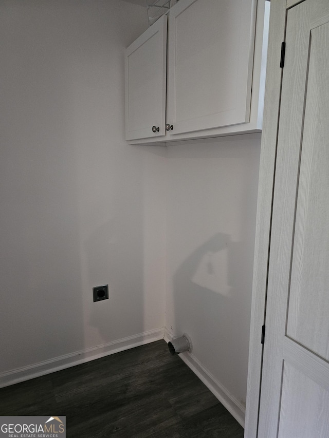 laundry area featuring cabinets, dark wood-type flooring, and hookup for an electric dryer