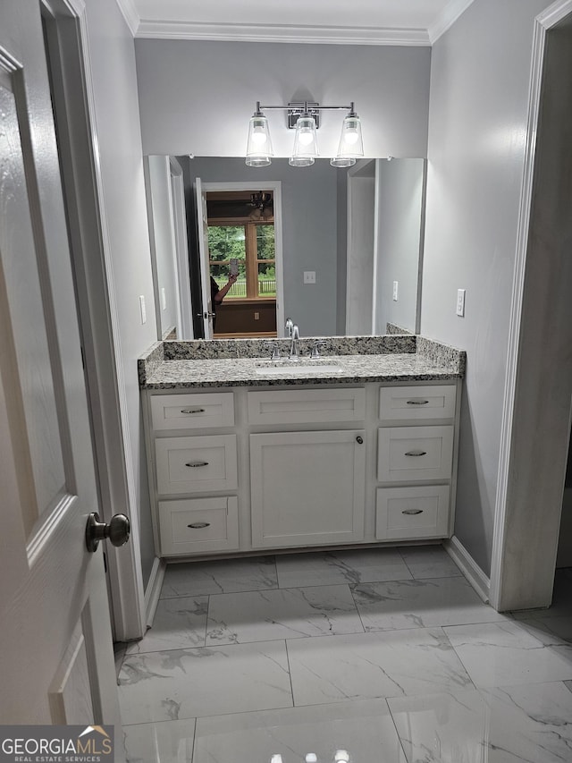 bathroom featuring crown molding and vanity