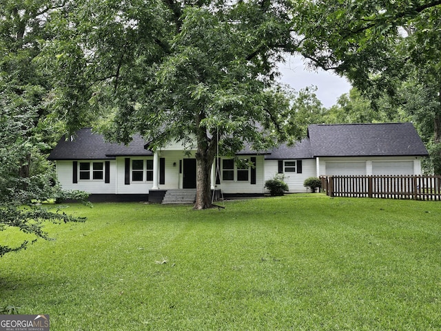 view of front of house with a garage and a front yard