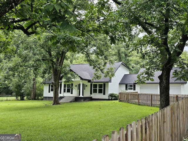 view of front of property with a garage and a front lawn