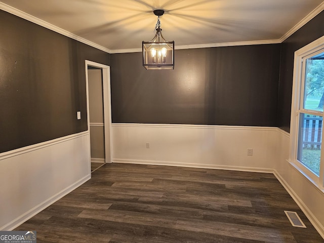 unfurnished dining area with ornamental molding, dark hardwood / wood-style floors, and an inviting chandelier