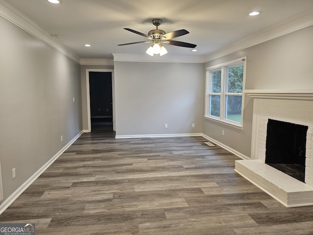 unfurnished living room featuring hardwood / wood-style floors, a fireplace, ornamental molding, and ceiling fan