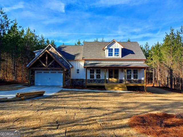 view of front of home with a porch and a garage