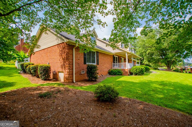 exterior space with a yard and covered porch