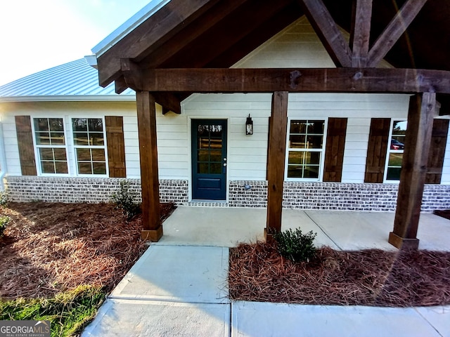 view of exterior entry with a porch