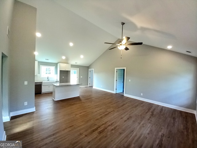 kitchen with white cabinetry, high vaulted ceiling, dark hardwood / wood-style flooring, and stainless steel dishwasher