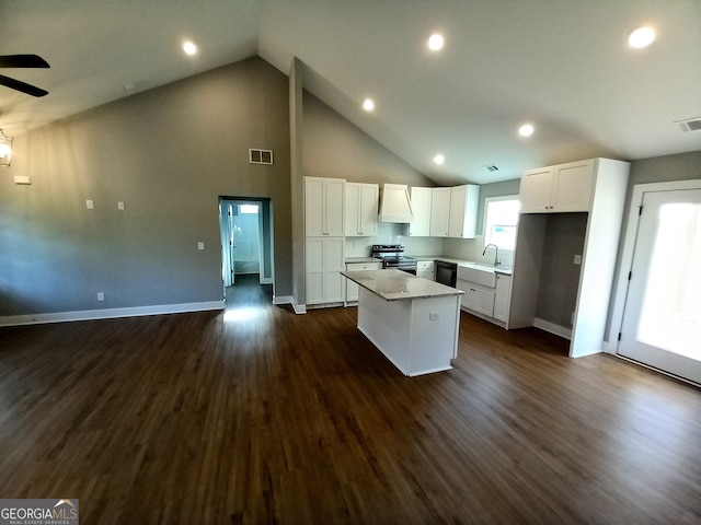 kitchen with black appliances, a center island, dark hardwood / wood-style floors, and white cabinetry