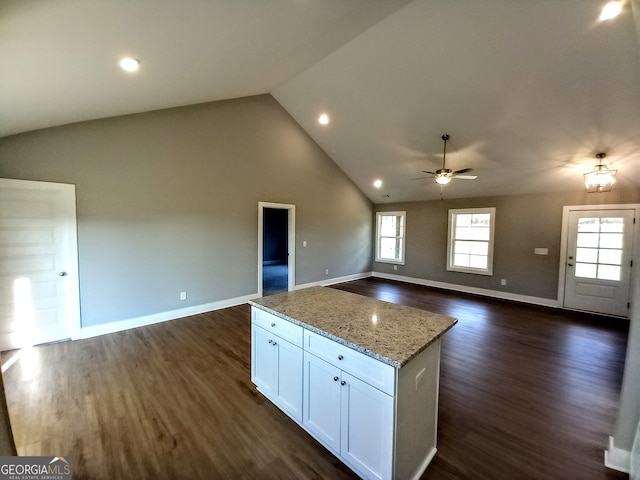 kitchen featuring white cabinetry, ceiling fan, light stone counters, and dark hardwood / wood-style flooring